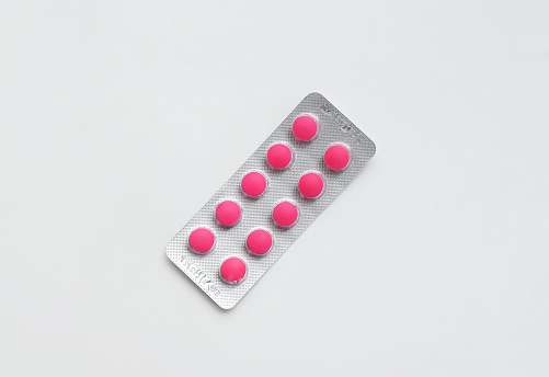 Pack of Pills pink on the table. Close up of Ibuprofen medicine in a blister pack. Medicine, health care concept.