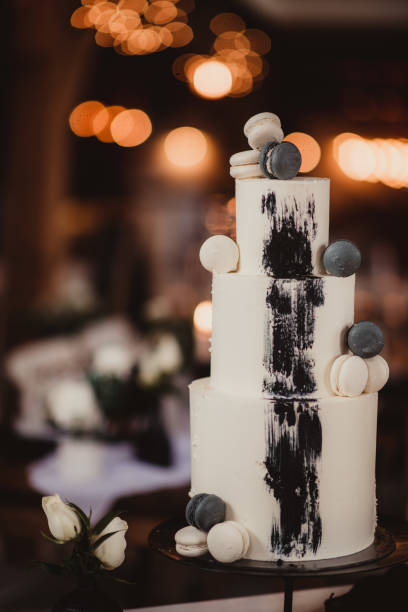 istock Tiered black and white wedding cake with French macarons 1483751147