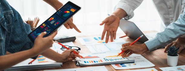 istock Analyst team utilizing BI Fintech to analyze with tablet. Scrutinize 1483751595