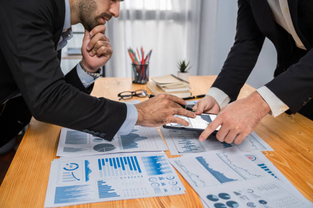 istock Busy analyst team discussing financial data on tablet. Fervent 1483754688