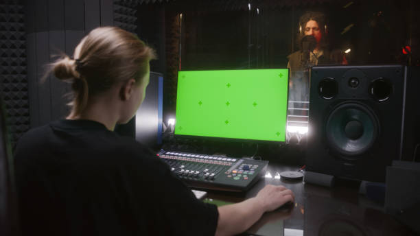 istock Female audio engineer works on PC in sound recording studio 1483756209