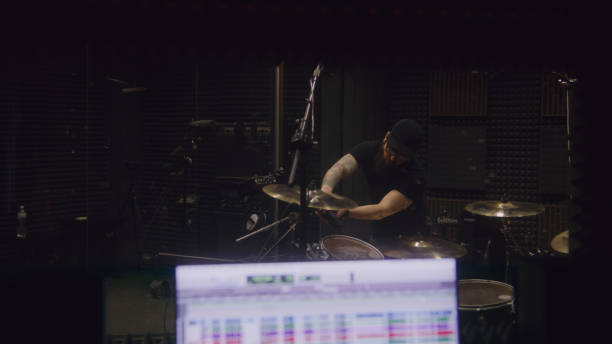 istock Sound engineer tunes musical instruments in recording room 1483757334