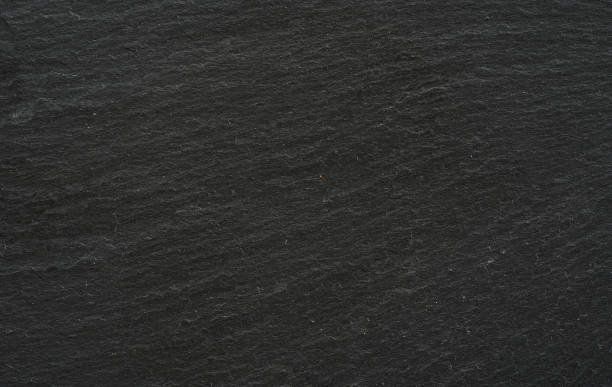 istock dark grey black slate stone texture background. close up dark grey black slate stone texture background. black slate stone texture 1483757589