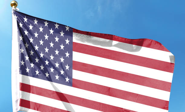 istock American flag on cloudy sky. waving in the sky 1483759291