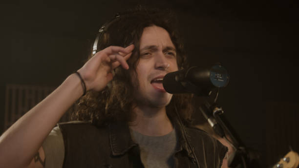 istock Vocalist sings into microphone in soundproof room 1483759898