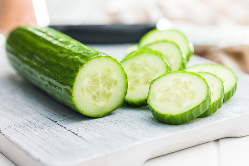 Sliced fresh green cucumber on the cutting board.