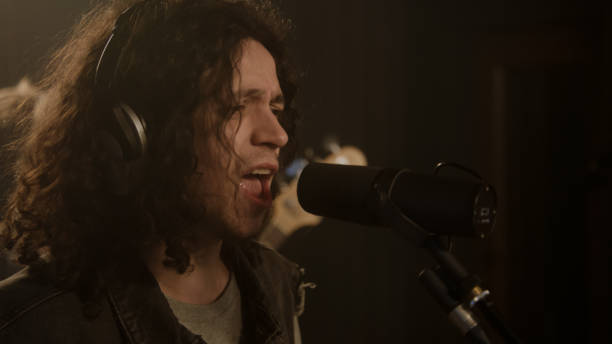 istock Vocalist sings into microphone in soundproof room 1483760382
