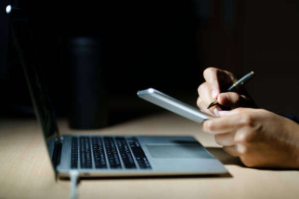 istock Business planning, E learning concept. Man hand with pen working on laptop computer at home office. 1483761126
