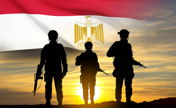 istock Silhouettes of soldiers against the sunset with Egypt flag 1483761204