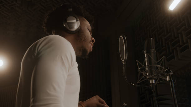 istock Vocalist sings in sound recording studio 1483765461