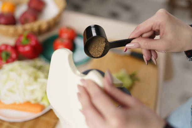 istock Woman pouring bokashi ferment in a compost bin at home 1483765748