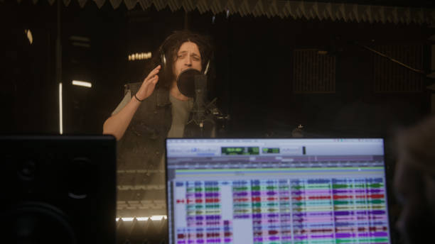 istock Female sound engineer works with singer in studio 1483767096