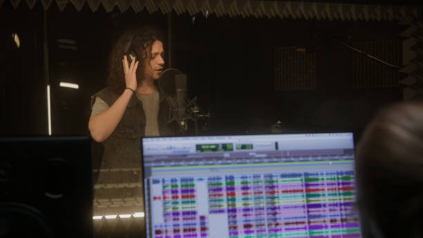 istock Female sound engineer works with singer in studio 1483767124