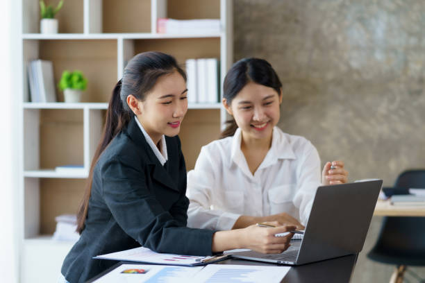 istock Two professional Asian business women discuss work using a laptop computer to work in the office. 1483767448