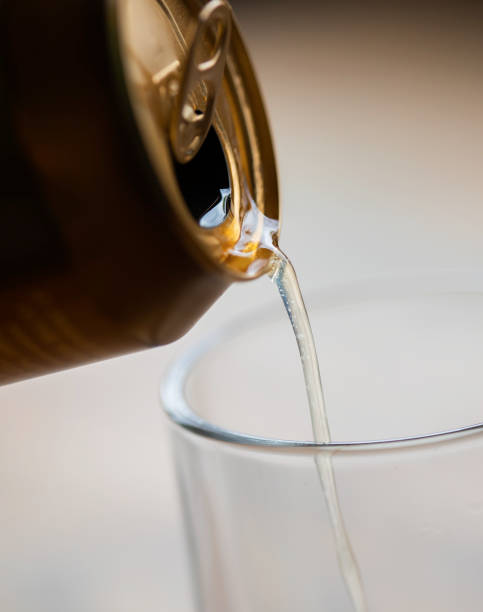 istock Pouring beer from can into glass closeup. 1483767552