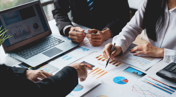 istock Group of business people meeting to plan, analyze, graph and chart corporate growth to plan new business expansions in the future. 1483768430