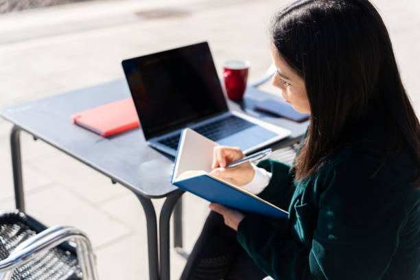 istock Freelance latin woman works while having a coffe in the train station 1483770362