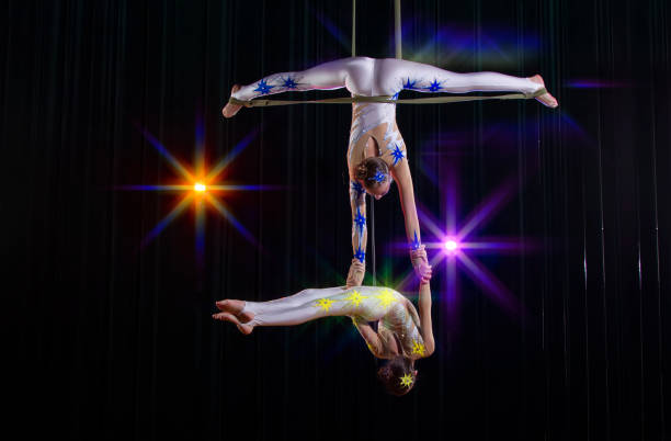 istock Circus acrobats gymnasts perform on a stage dark background. 1483770643