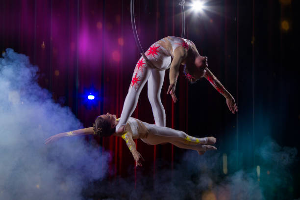 istock Circus acrobats gymnasts perform on a stage dark background. 1483770653