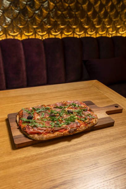 istock Arugula prosciutto pizza served on a wooden board 1483771117