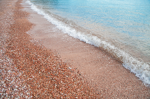 Sveti Stefan beach with red stones in Budva