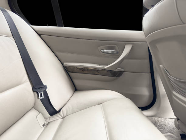 istock Back passenger white leather seats in modern luxury car. White perforated leather with stitching. Car inside. Leather comfortable red seats. Car interior details 1483772395