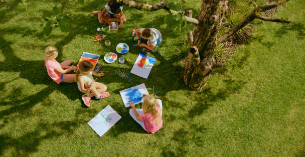 Children drawing in garden