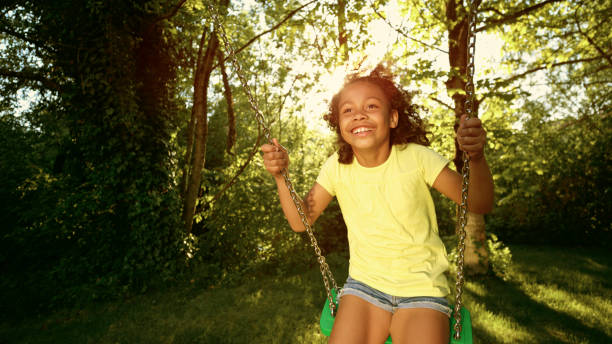 istock Girl playing on swing 1483772737