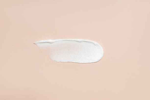 istock Cosmetic product smear white moisturizing lotion cream on beige, squeezed out and smeared portion of skincare cream product testing. 1483775165