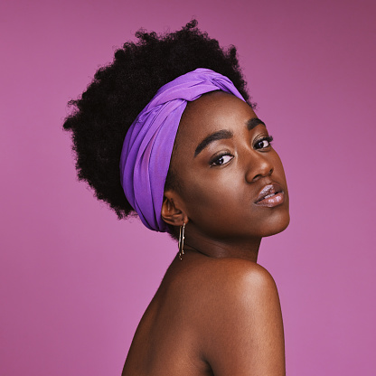 Portrait, beauty and aesthetic with a model black woman on a pink background in studio for natural skincare. Face, hair or headband with an attractive young female posing to promote cosmetics