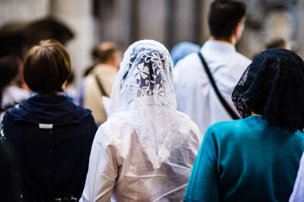 Catholic faithful in church women with veils over their heads