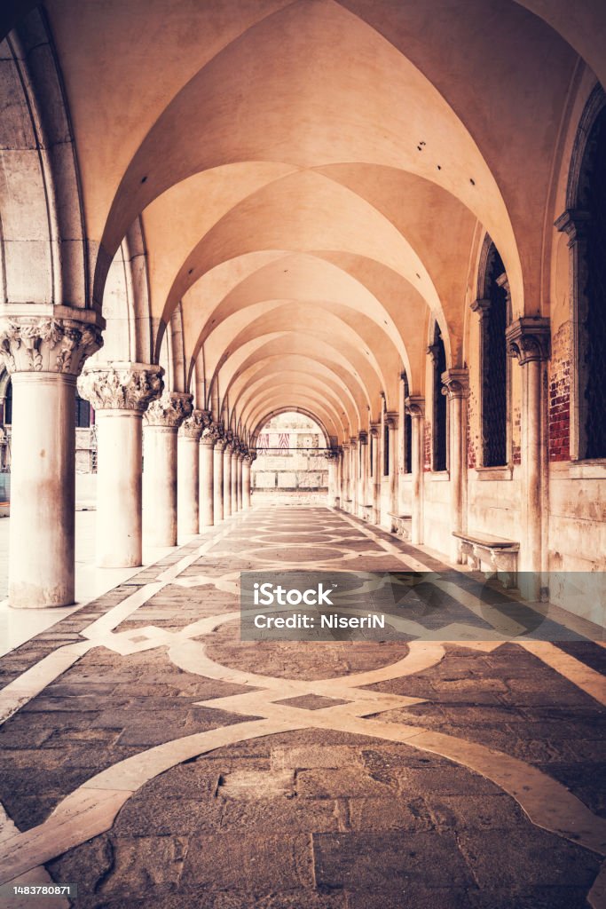 Ancient columns with arches at Palazzo Ducale or Doge's Palace in Venice, Italy Ancient columns with arches at Palazzo Ducale or Doge's Palace in Venice, Italy at sunrise Ancient Stock Photo