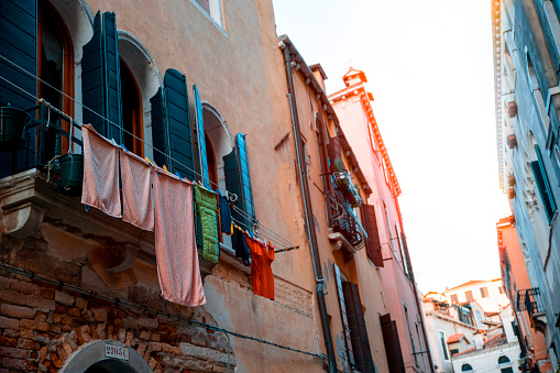 Italian building facades with laundry hanging on the walls. Copy space