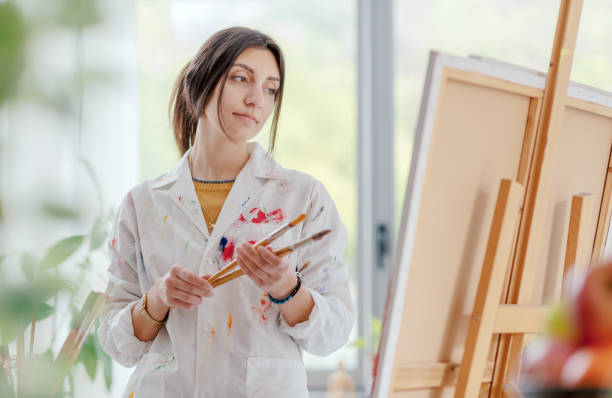 istock Young artist looking at her artwork 1483782418