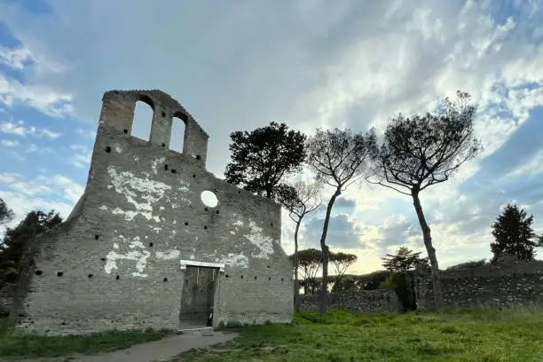 The ancient Church of San Nicola in Capo di Bove stands along the Appia Antica, in Rome. Its simple and linear architecture encloses a single nave interior.