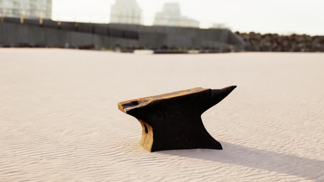 Old anvil on a sandy beach