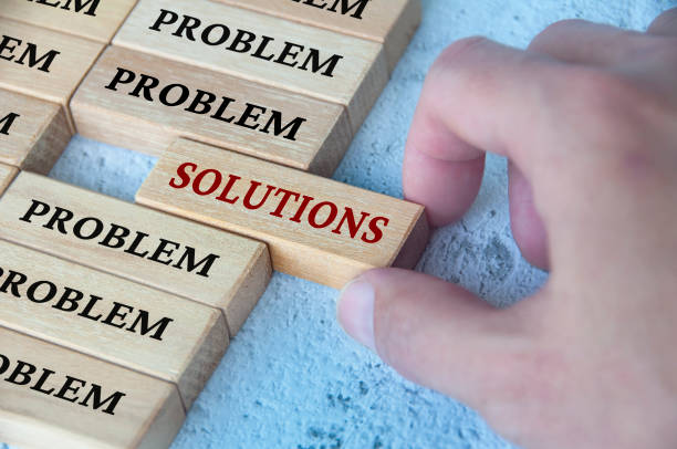 Hand placing wooden blocks with solutions text text on wooden blocks. Solutions to problems concept