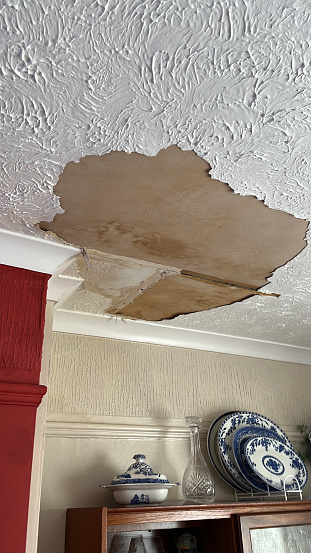 istock Water leak damage to living room ceiling 1483793585