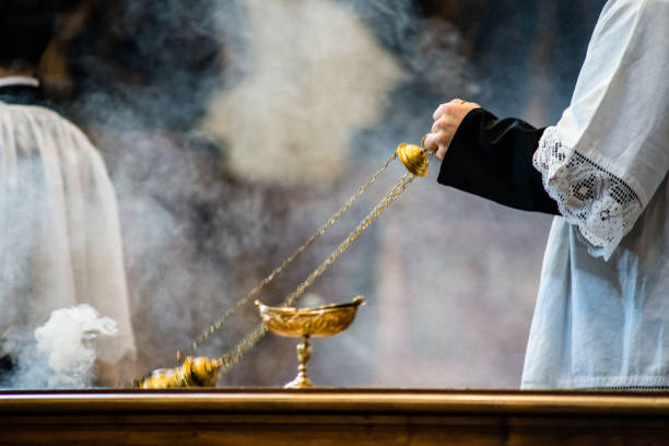 altar boy of the catholic church with thurible in his hand during a celebration
