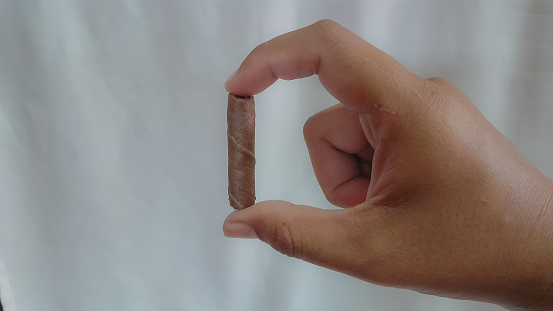 people holding chocolate wafer rolls isolated on white background