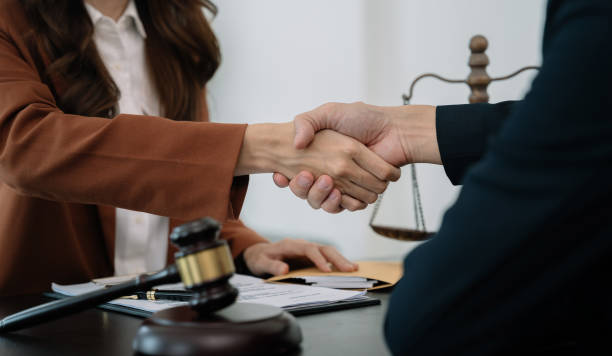 istock partner lawyers attorneys shaking hands after discussing a contract agreement done. 1483799951