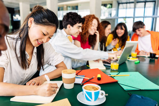 istock Young multiracial college students studying together at campus cafeteria terrace 1483800660