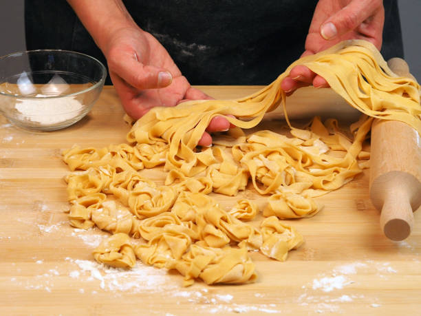 istock Chef prepares noodles at home in the kitchen 1483801195