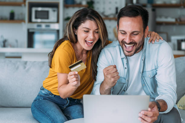 istock Lovely couple using laptop for online shopping. 1483802351