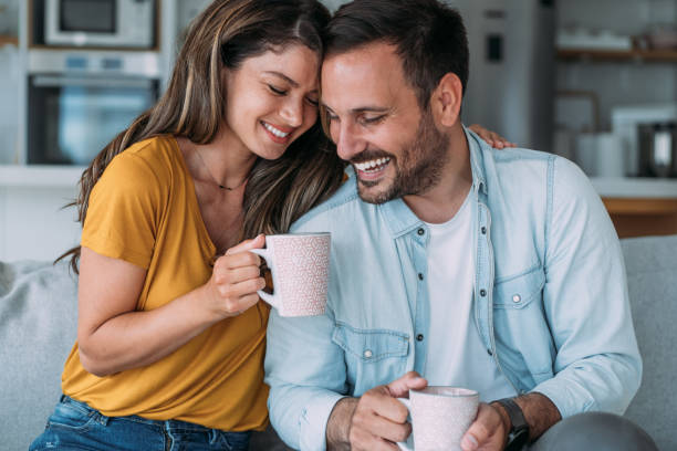 istock Lovely young couple drinking coffee at home. 1483802370