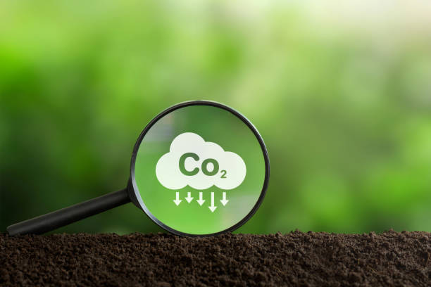 istock Reduce CO2 emission concept. Clean and friendly environment without carbon dioxide emissions.CO2 reducing icon inside magnifier glass for carbon credit to limit global warming from climate change 1483803510