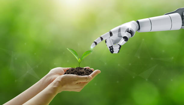 istock environment Earth Day. Hands holding trees growing with a robotic hand touching the tree collaboration between humans and technology to protect the environment together. Environmental technology.SDGs. 1483803617
