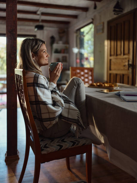 istock Relaxed woman day dreaming during coffee time at home. 1483806831