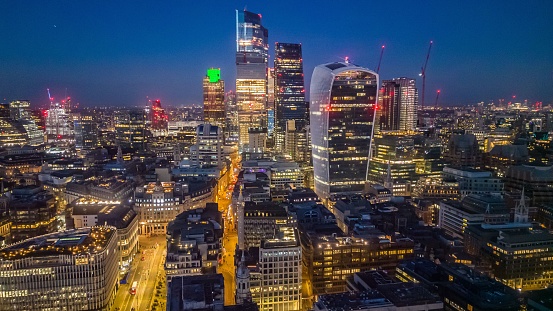 An aerial view of the London skyline illuminated during blue hour, United Kingdom.