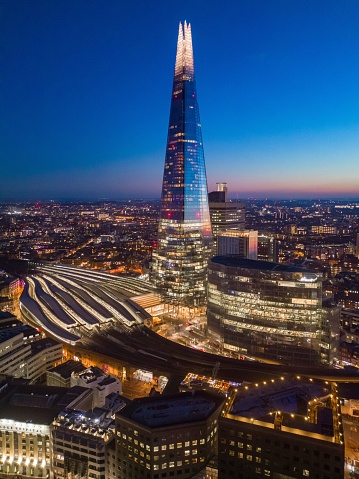 An aerial view of the London skyline illuminated during blue hour, United Kingdom.